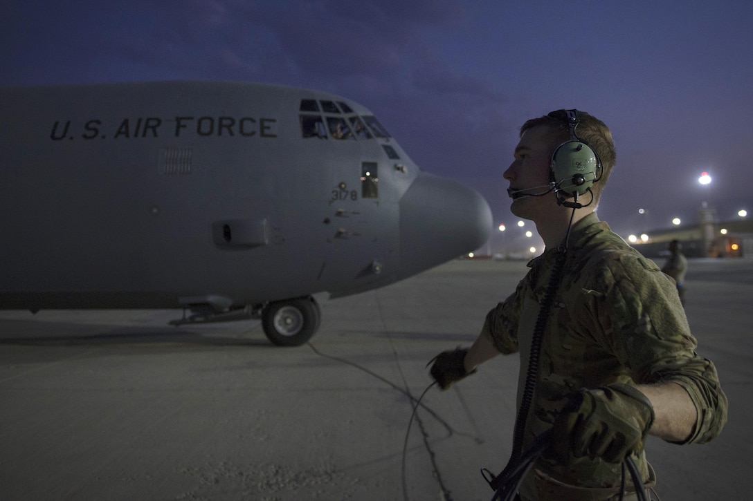 Air Force Senior Airman Tom Saunders performs final checks on a C-130J Super Hercules