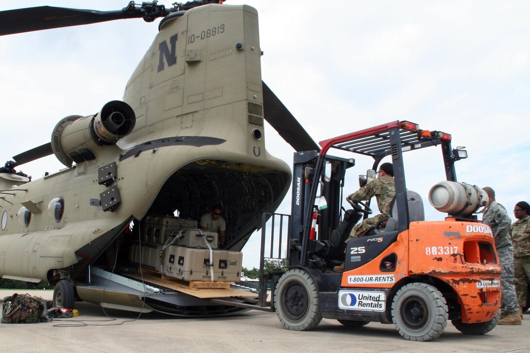 Cargo plane receives supplies loaded by forklift
