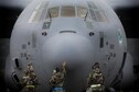 Crew chiefs from the 374th Aircraft Maintenance Squadron await a C-130J Super Hercules engine to start during Exercise Beverly Morning 17-05 at Yokota Air Base, Japan, Aug. 18, 2017. The training is designed to test the ability of Airmen to survive in austere environments with chemical, biological, radiological, nuclear and explosive hazards. (U.S. Air Force photo/Yasuo Osakabe)