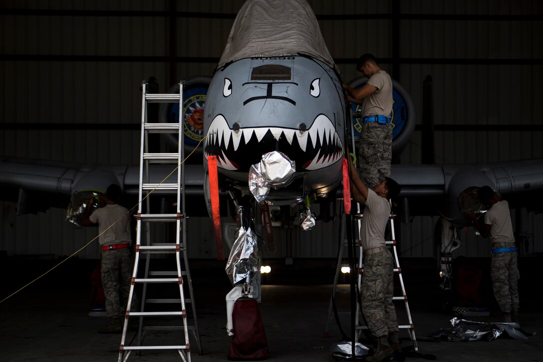 Members of the 23d Aircraft Maintenance Squadron prepare an A-10C Thunderbolt II to be washed, Aug. 28, 2017, at Moody Air Force Base, Ga. Maintenance procedures require that A-10s are washed at least every 180 days to prevent maintenance issues and safety hazards to the pilot. Since strong chemicals are used to clean the aircraft Airmen must wear personal protective equipment. (U.S. Air Force photo by Airman 1st Class Daniel Snider)