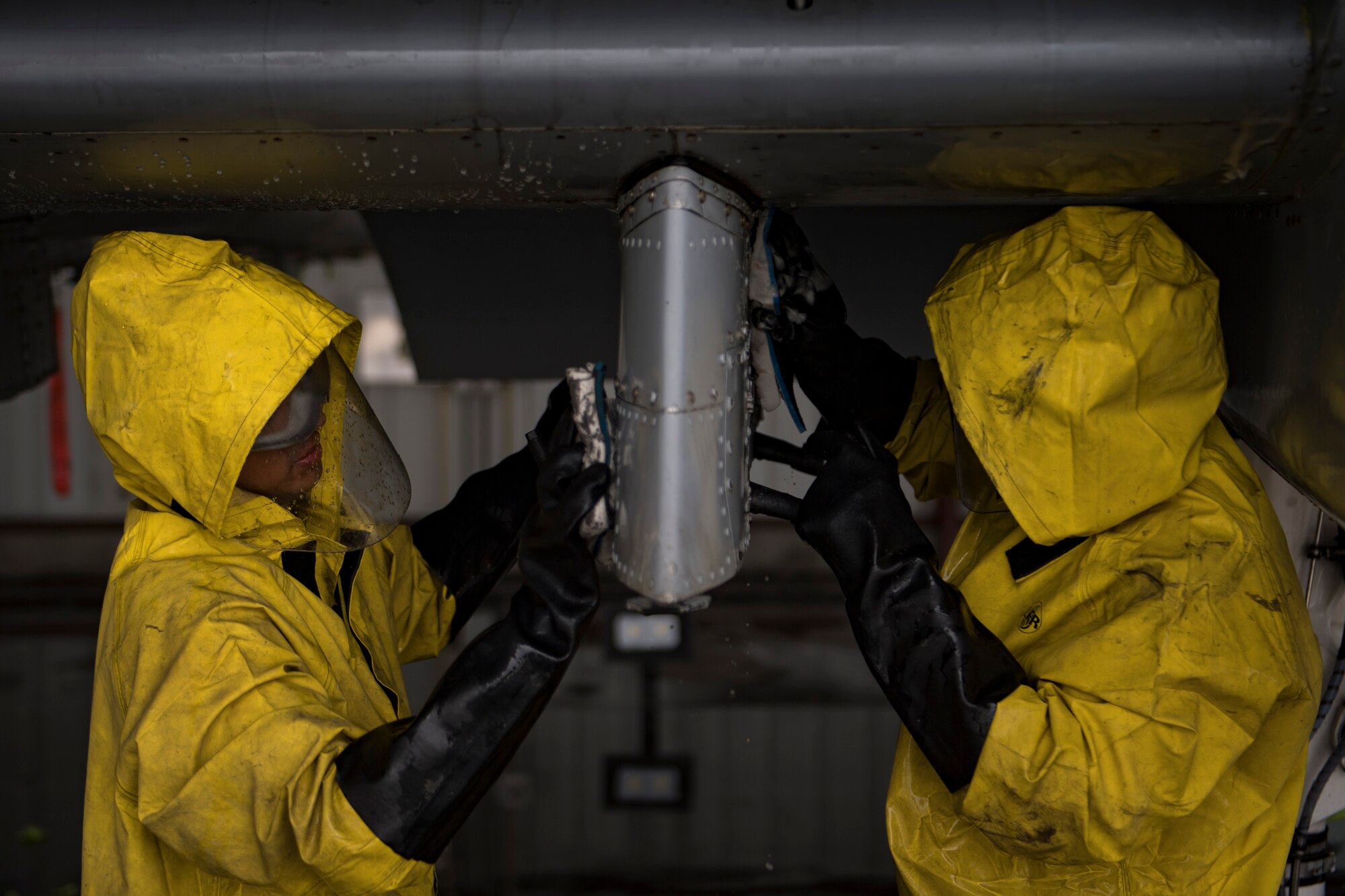 Members of the 23d Aircraft Maintenance Squadron clean under a wing of an A-10C Thunderbolt II, Aug. 28, 2017, at Moody Air Force Base, Ga. Maintenance procedures require that A-10s are washed at least every 180 days to prevent maintenance issues and safety hazards to the pilot. Since strong chemicals are used to clean the aircraft Airmen must wear personal protective equipment. (U.S. Air Force photo by Airman 1st Class Daniel Snider)
