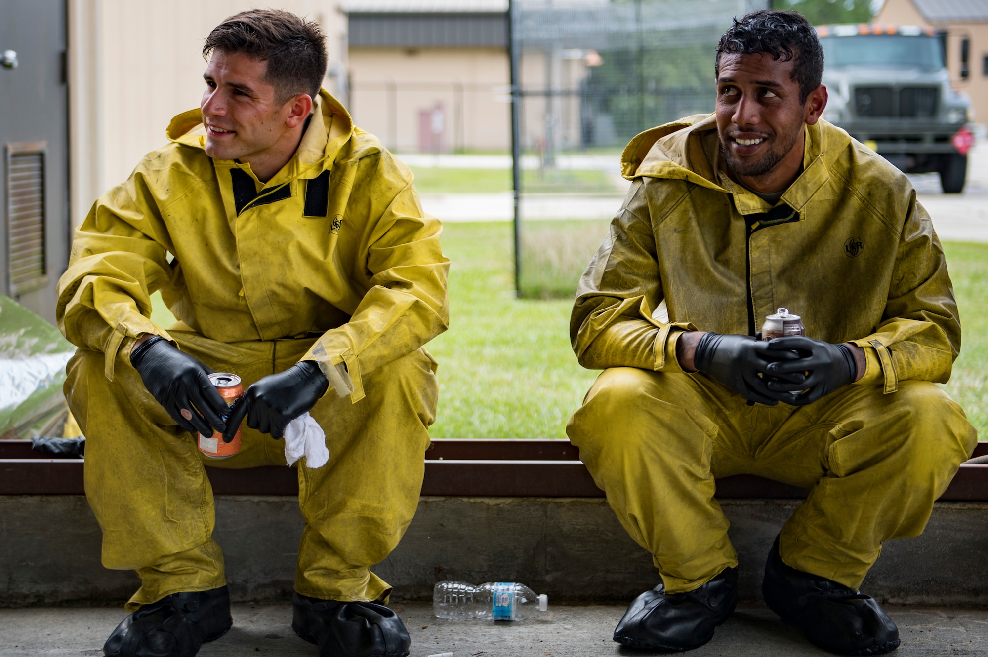 Airman 1st Class Jake Dromgold, left, and Senior Airman Daniel Ioane, both 23d Aircraft Maintenance Squadron crew chiefs, rest for a moment while washing an A-10C Thunderbolt II, Aug. 28, 2017, at Moody Air Force Base, Ga. Maintenance procedures require that A-10s are washed at least every 180 days to prevent maintenance issues and safety hazards to the pilot. Since strong chemicals are used to clean the aircraft Airmen must wear personal protective equipment. (U.S. Air Force photo by Airman 1st Class Daniel Snider)