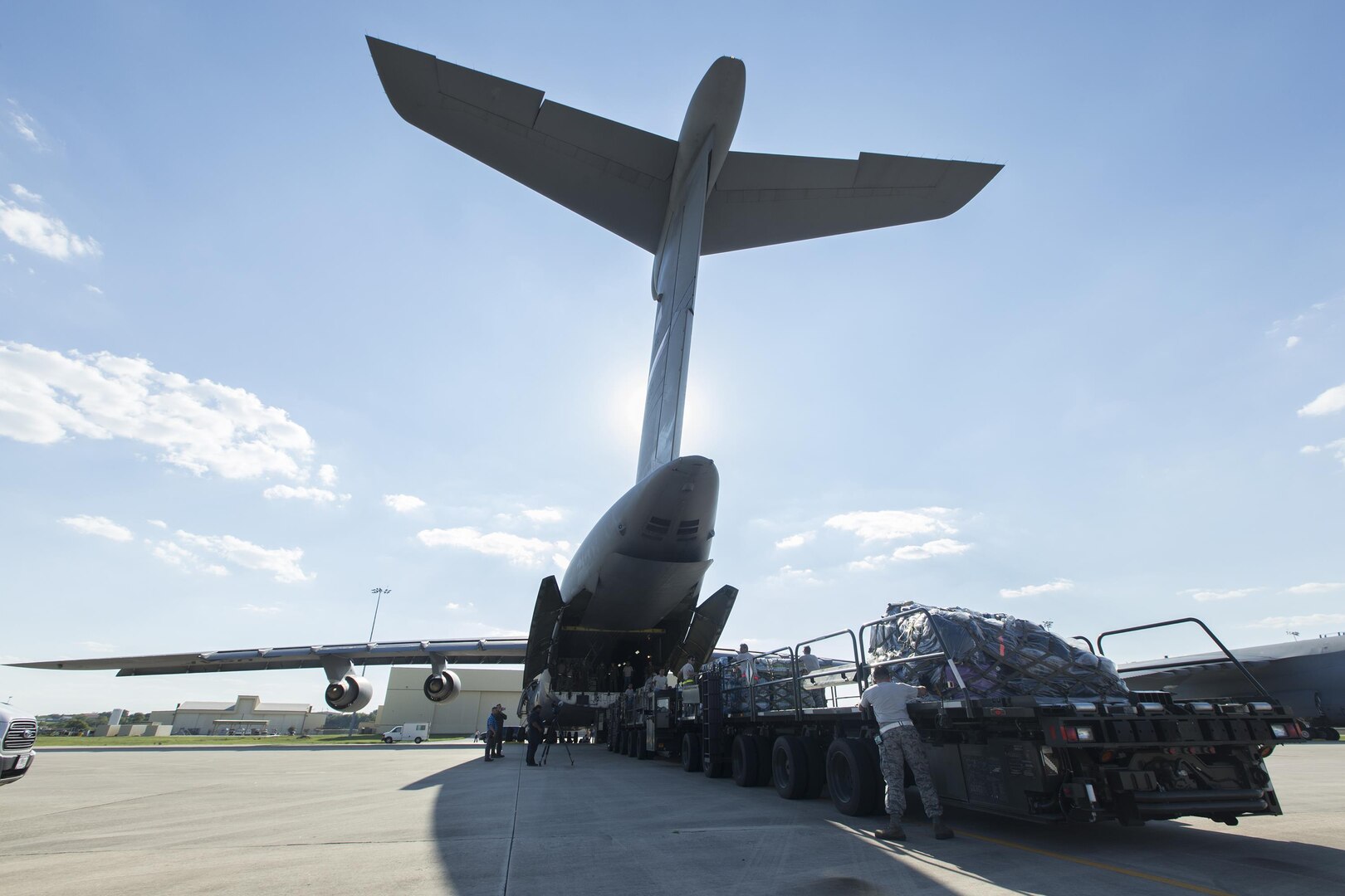 U.S. Air Force Personnel with 502nd Logistics Readiness Squadron load supplies and equipment on a military aircraft