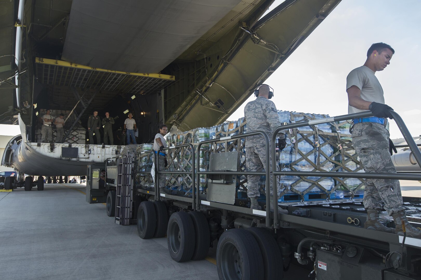 U.S. Air Force Personnel with 502nd Logistics Readiness Squadron load supplies and equipment on a military aircraft