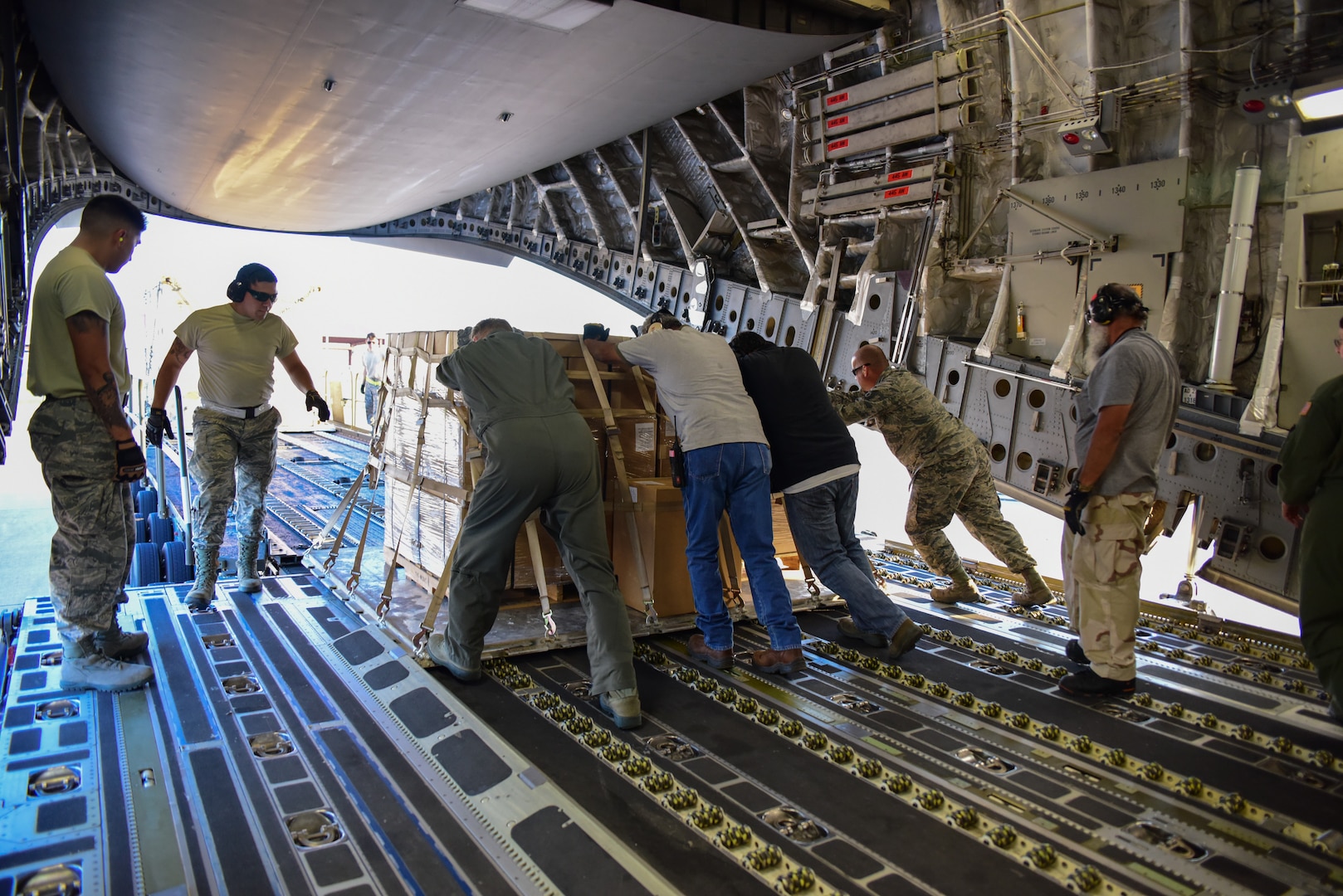 Members from the 502nd Logistics Readiness Squadron, the 433rd Airlift Wing, and the 445th Airlift Wing unload pallets and rolling stock containing maintenance equipment Aug. 30, 2017 at Joint Base San Antonio-Lackland Kelly Field, Texas.