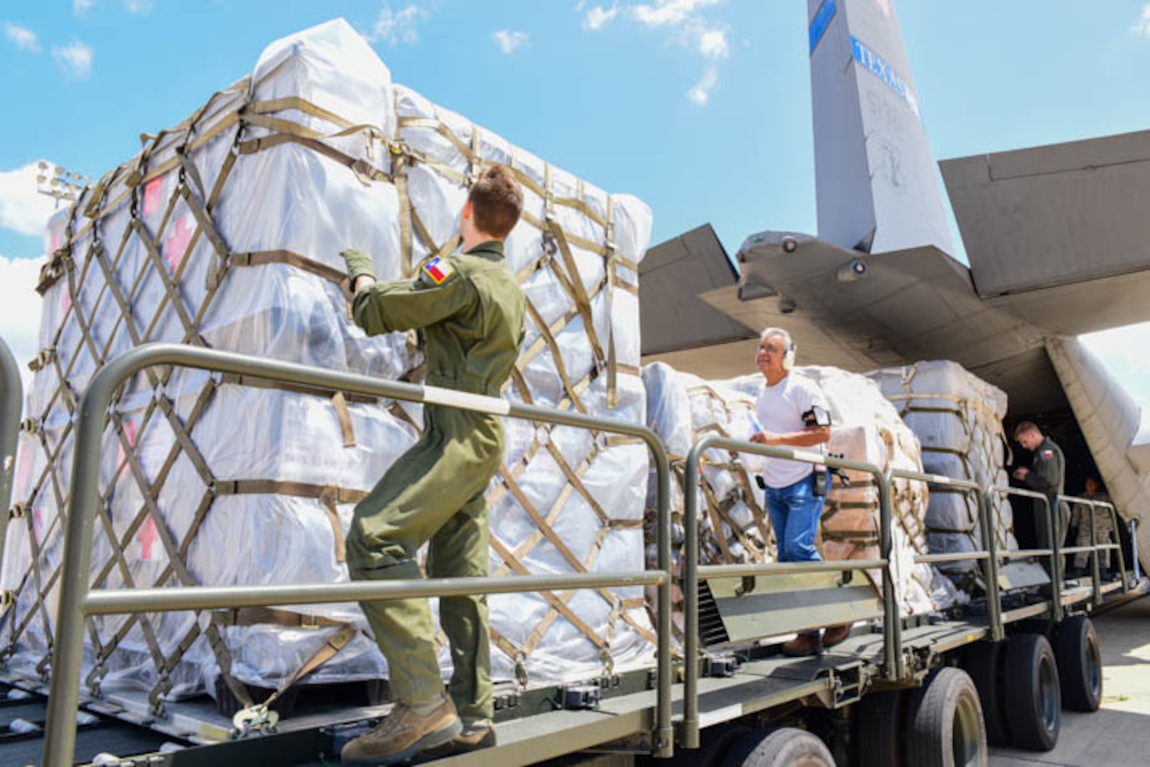 Texas Air National Guard airmen load a Lockheed C-130 Hercules on the flightline