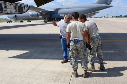 Members from the 502nd Logistics Readiness Squadron and the 433rd Airlift Wing load pallets containing medical supplies and equipment