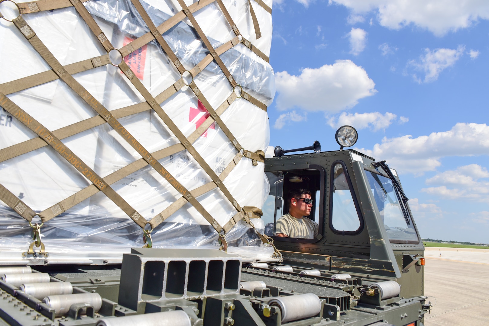 Members from the 502nd Logistics Readiness Squadron and the 433rd Airlift Wing load pallets containing medical supplies and equipment