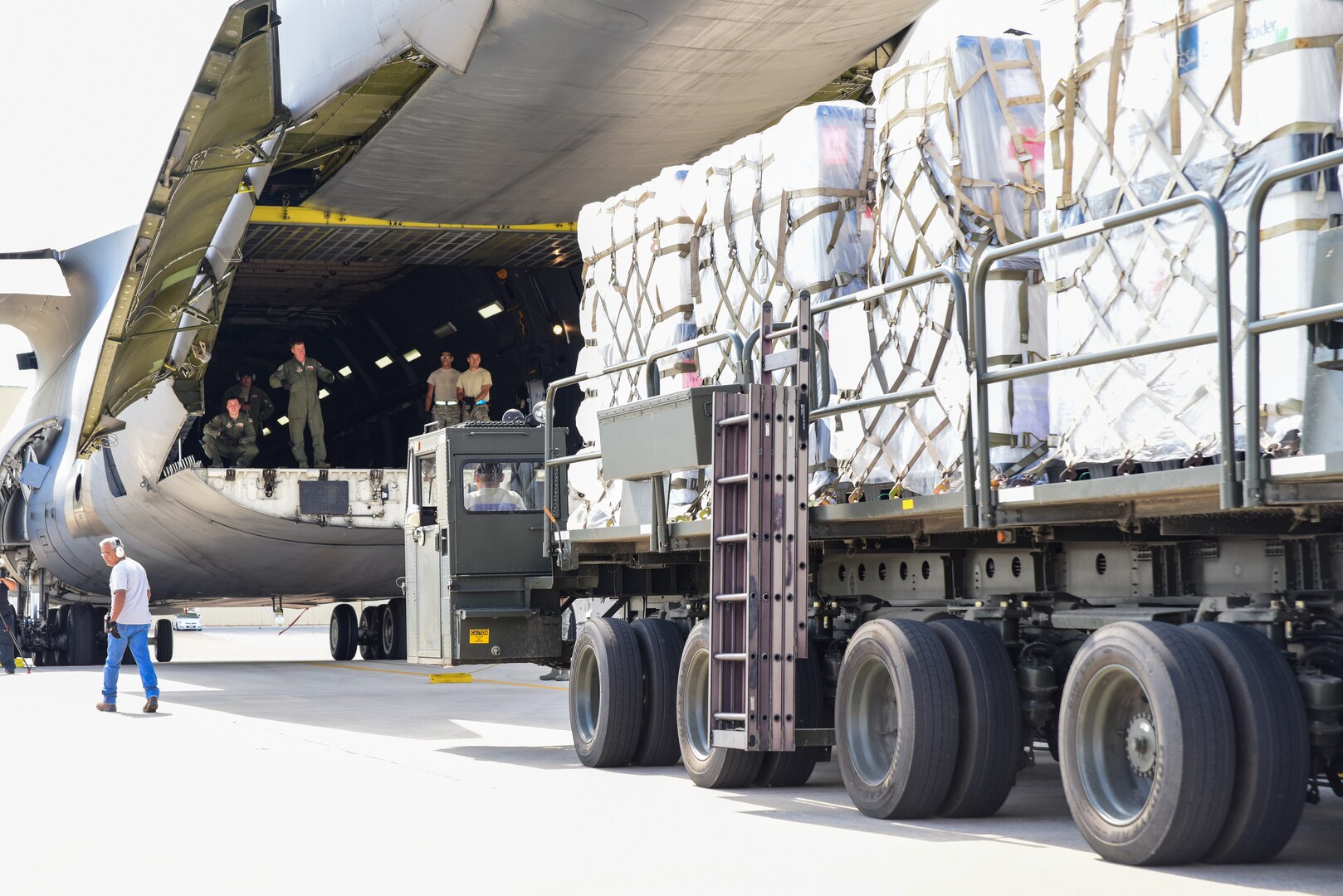 Members from the 502nd Logistics Readiness Squadron and the 433rd Airlift Wing load pallets containing medical supplies and equipment