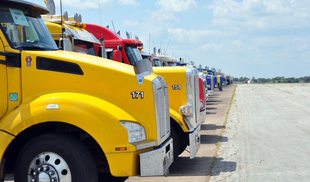 Fuel trucks in line on airfield tarmac