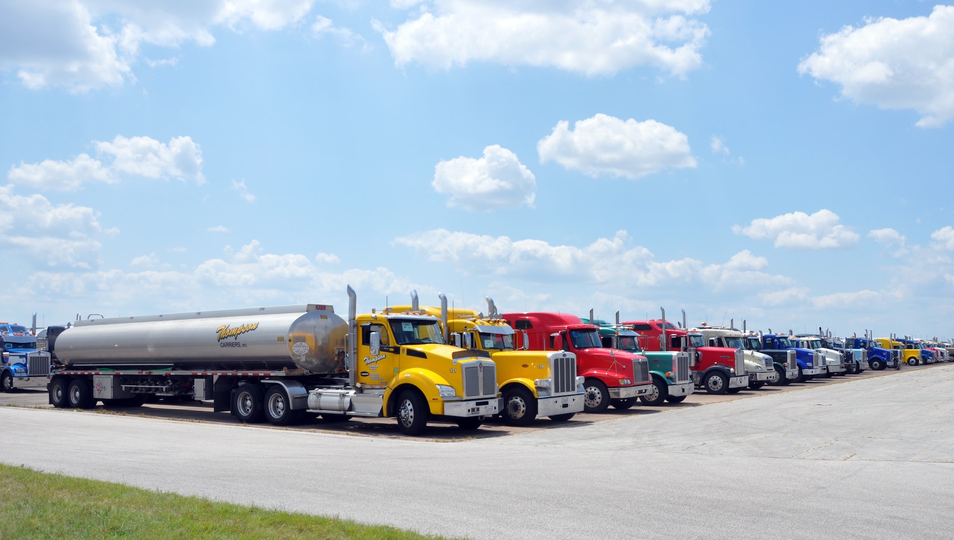 Fuel trucks in line on airfield tarmac