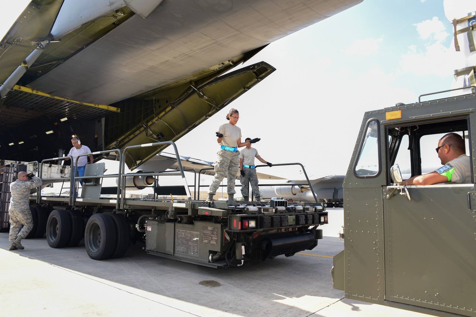 Members from the 502nd Logistics Readiness Squadron and the 433rd Airlift Wing load pallets containing medical supplies and equipment