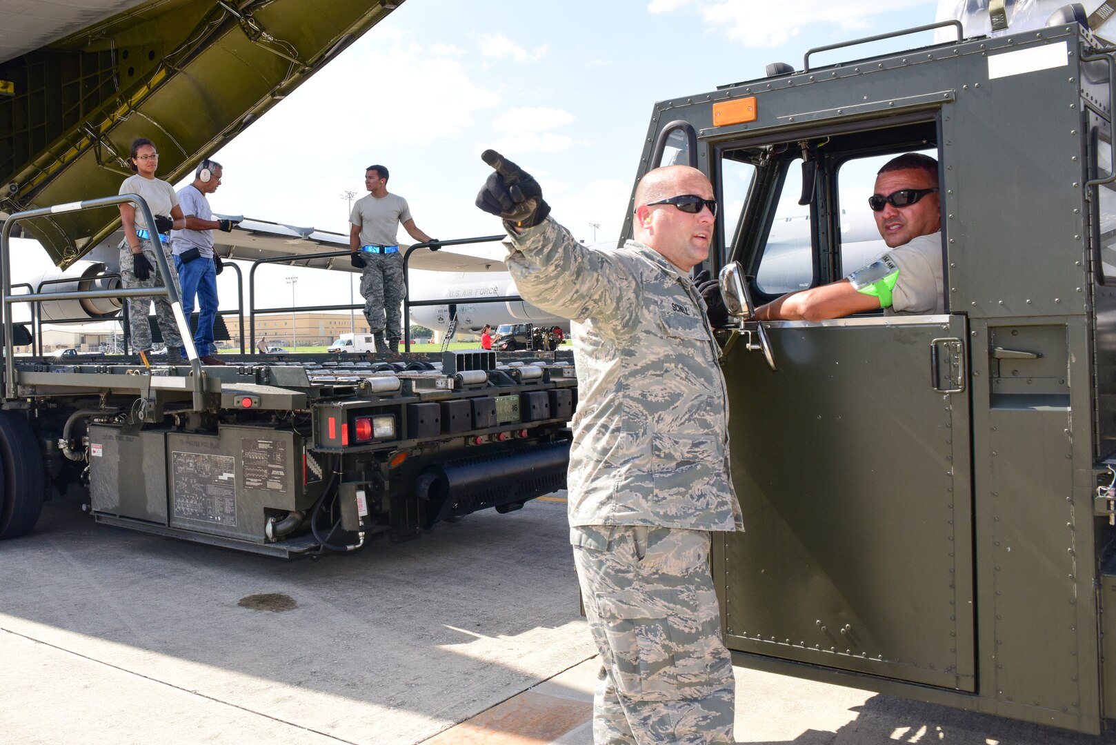 Members from the 502nd Logistics Readiness Squadron and the 433rd Airlift Wing load pallets containing medical supplies and equipment