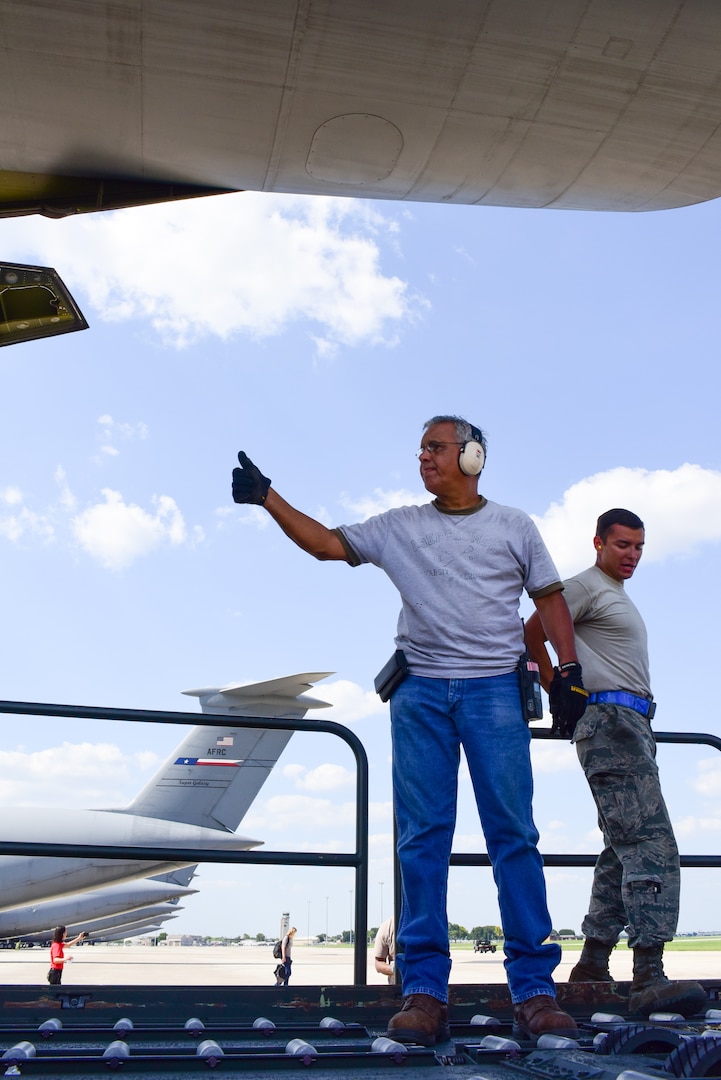 Members from the 502nd Logistics Readiness Squadron and the 433rd Airlift Wing load pallets containing medical supplies and equipment