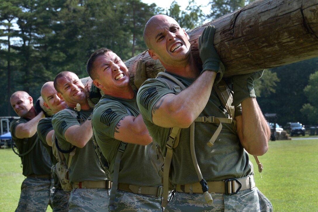 Tech. Sgt. Dedrick Baublitz, Airman 1st Class Adam Roach, and their team members lift a telephone pole