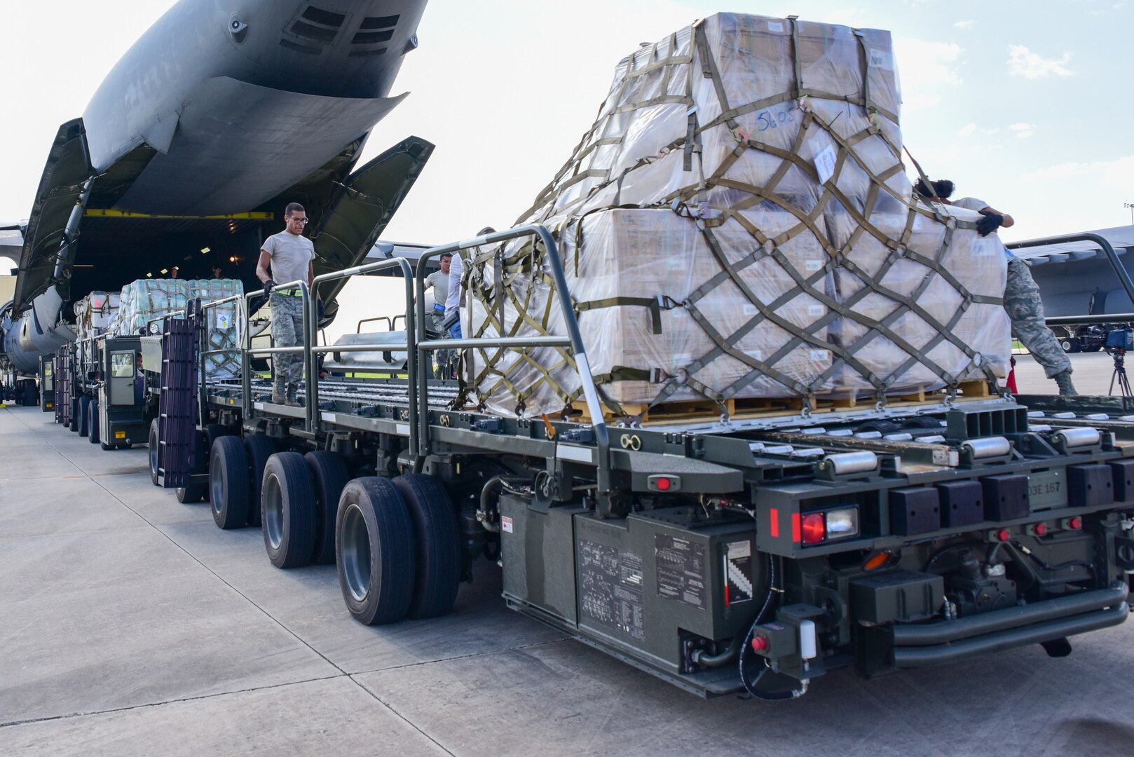 Members from the 502nd Logistics Readiness Squadron and the 433rd Airlift Wing load pallets containing medical supplies and equipment