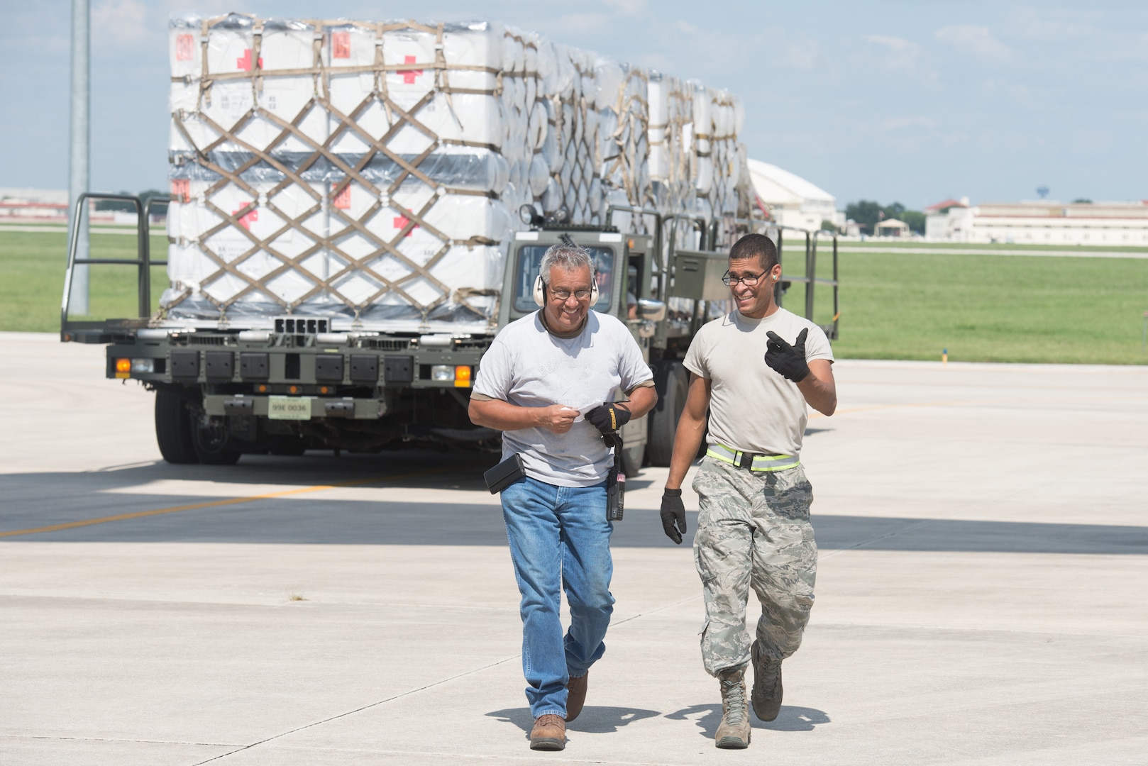 Members from the 502nd Logistics Readiness Squadron and the 433rd Airlift Wing load pallets containing medical supplies and equipment