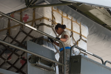 Members from the 502nd Logistics Readiness Squadron and the 433rd Airlift Wing load pallets containing medical supplies and equipment