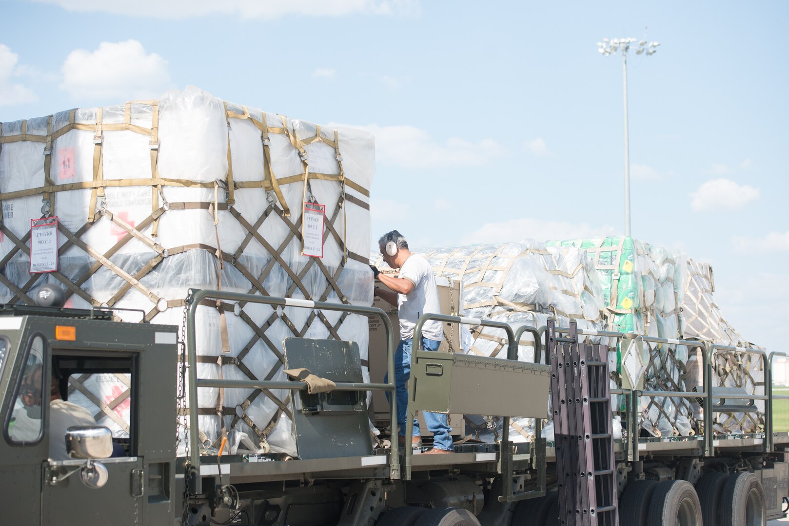 Members from the 502nd Logistics Readiness Squadron and the 433rd Airlift Wing load pallets containing medical supplies and equipment