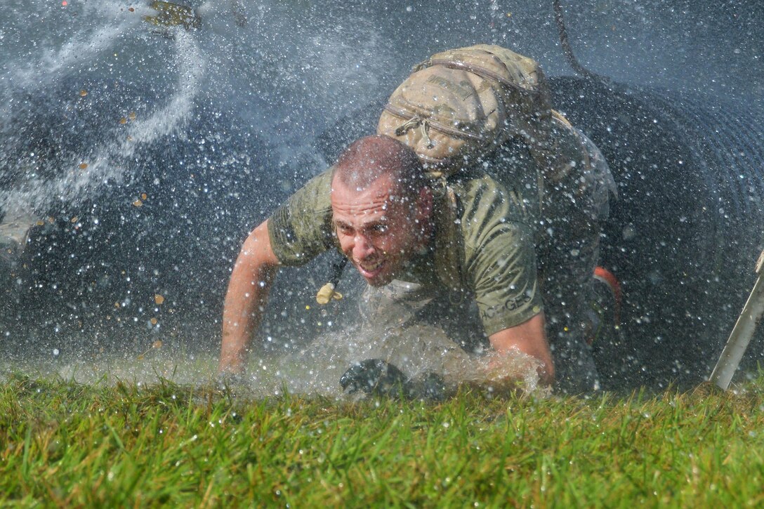 Master Sgt. Christopher Hodges crawls through plastic tubing as a part of an obstacle