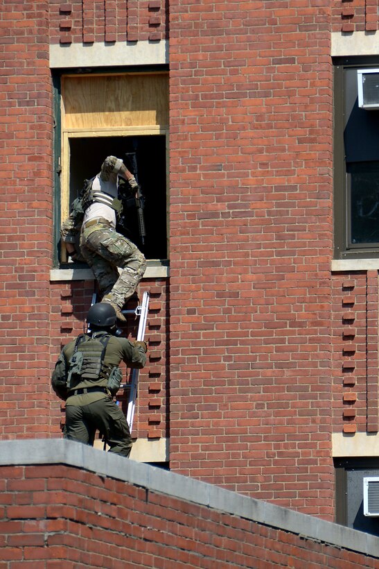 Guardsmen climb into an abandoned hospital as a part of an obstacle during the 2017 Connecticut SWAT Challenge
