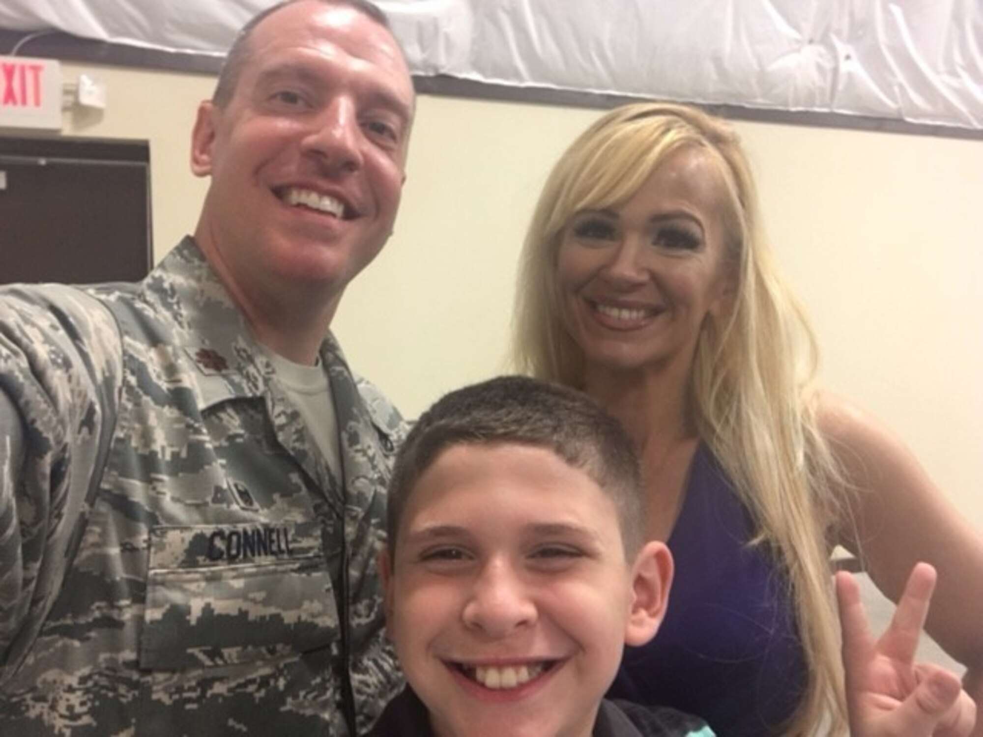 U.S. Air Force Maj. Joshua Connell, 823rd Red Horse Detachment 1 commander, poses for a photo with his wife and son.
