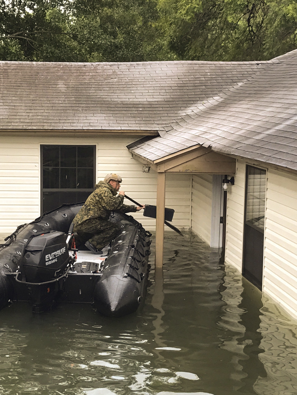 BEAUMONT, Texas – 1st Sgt. John Finney of 4th Reconnaissance Battalion, 4th Marine Division, Marine Forces Reserve, conducts door to door welfare checks in a U.S. Marine Corps F470 Zodiac Combat Rubber Raiding Craft during search and rescue operations in wake of Hurricane Harvey, in Beaumont, Texas, Aug. 30, 2017. Marine Forces Reserve is posturing ground, air, and logistics assets in order to support FEMA, state and local response efforts due to Hurricane Harvey. (Courtesy photo/Released)