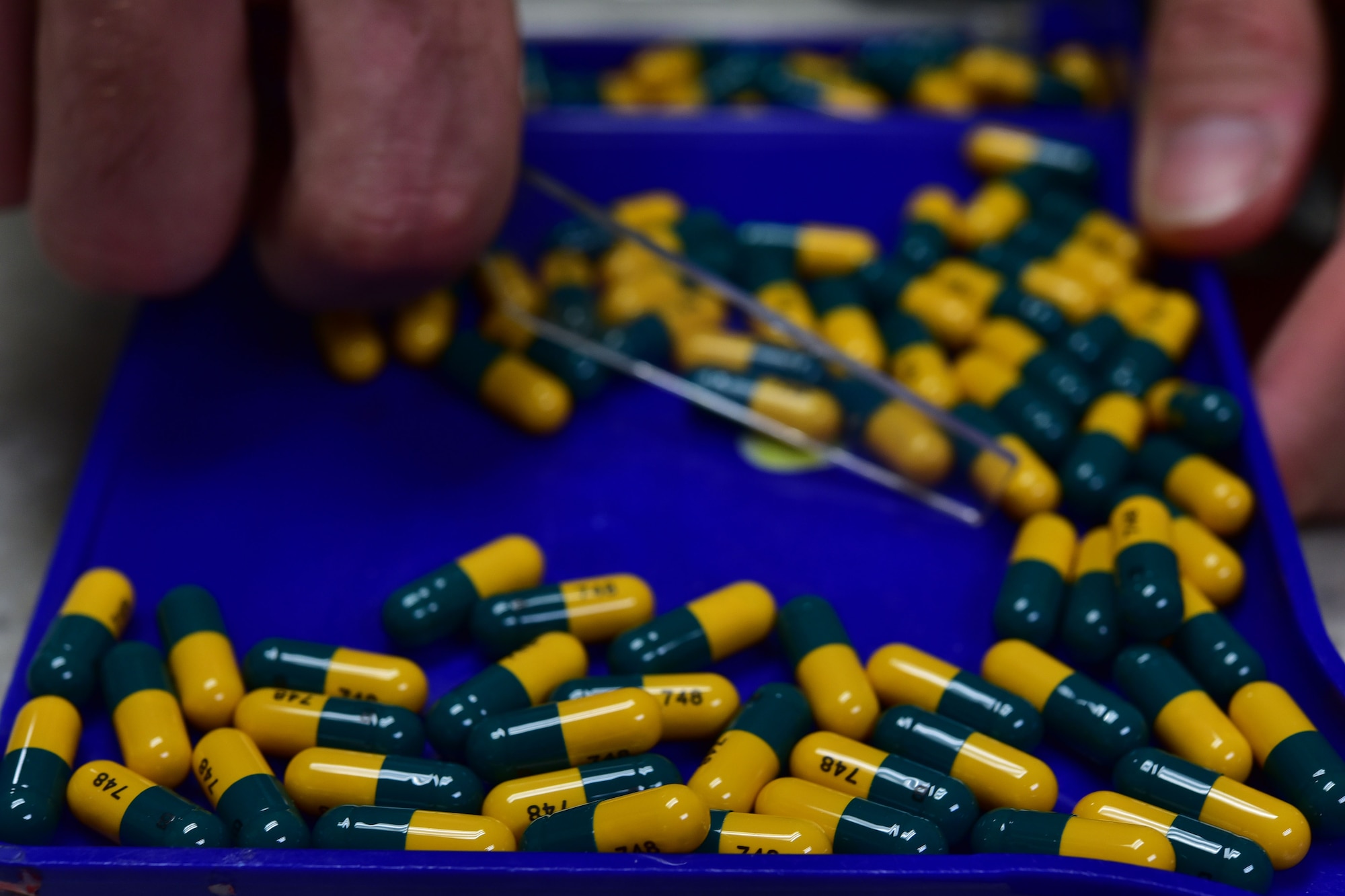 Airman 1st Class Joshua White, 19th Medical Support Squadron pharmacy technician, counts pill capsules Aug. 24, 2017 at Little Rock Air Force Base, Ark. Airmen going to areas prone to malaria are given Doxycycline and Primaquine tablets before they leave to help combat the disease. (U.S. Air Force photo by Airman Rhett Isbell)
