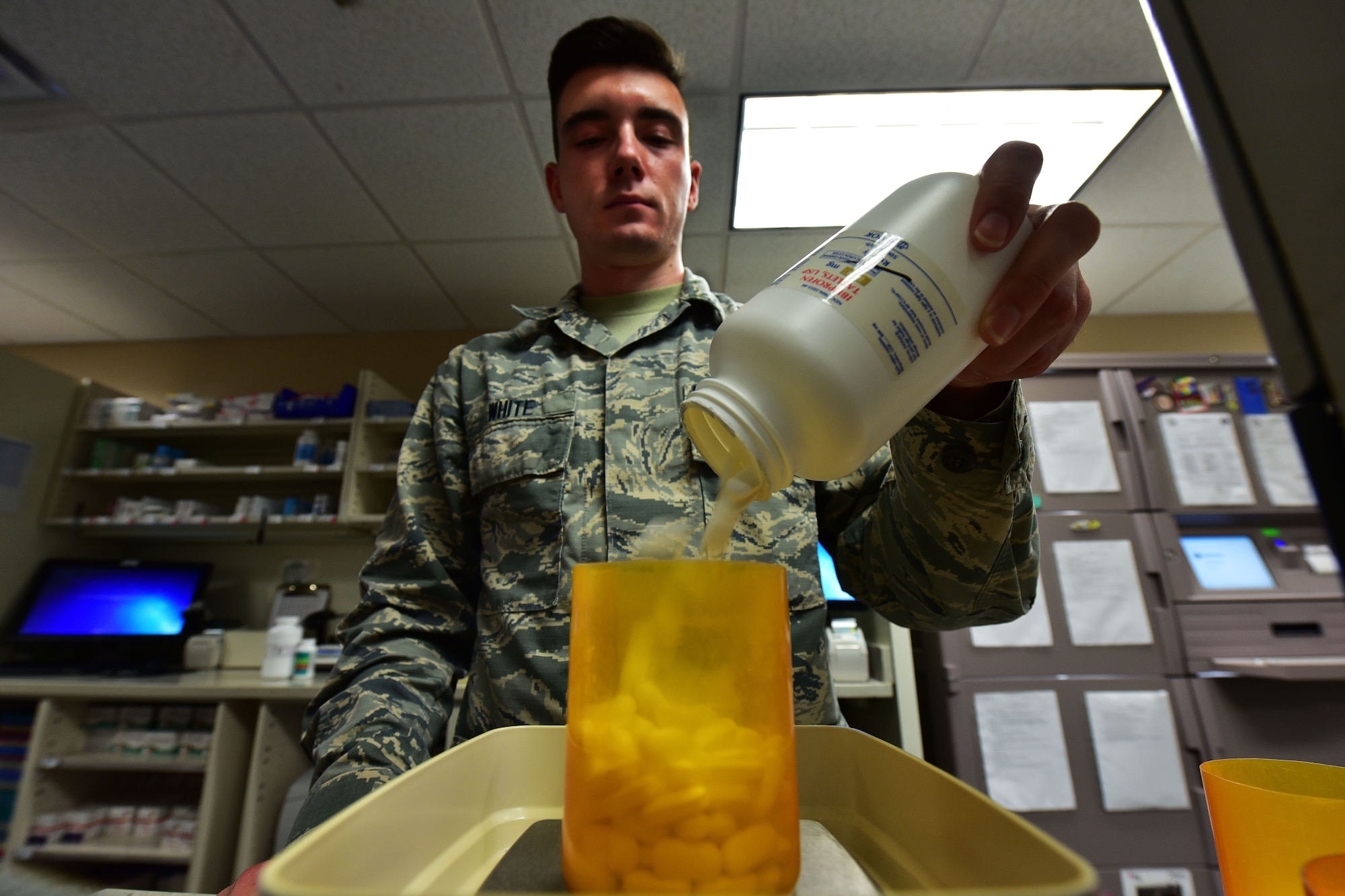 Airman 1st Class Joshua White, 19th Medical Support Squadron pharmacy technician, weighs pill capsules Aug. 24, 2017 at Little Rock Air Force Base, Ark. The Tricate Mail Order Pharmacy is available for members on deployment or temporary duty assignment who are in need of medication. (U.S. Air Force photo by Airman Rhett Isbell)