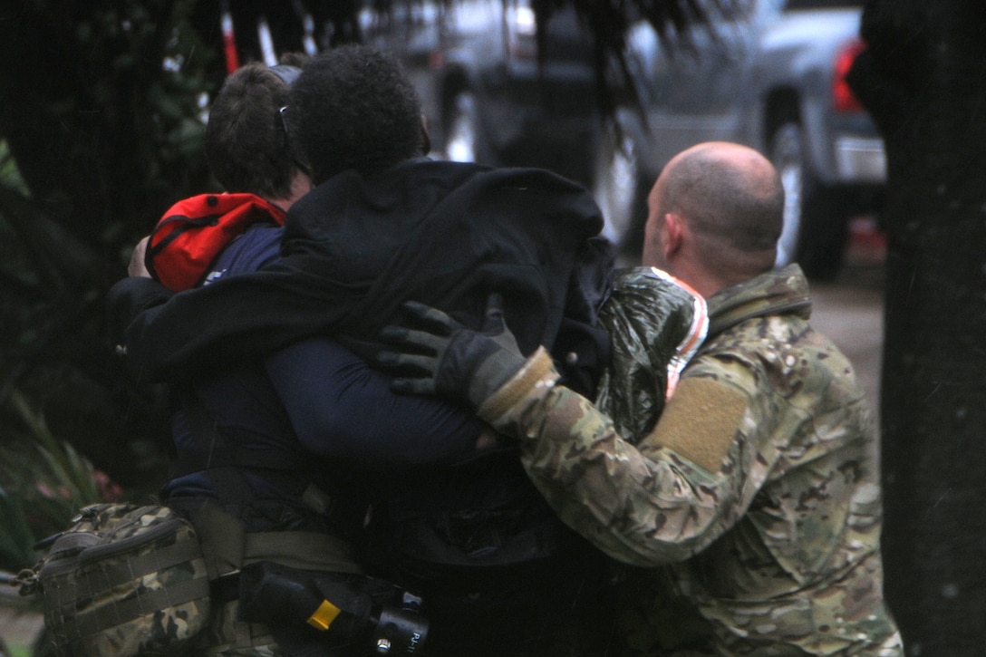 Two service members carry a person.