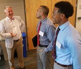 IMAGE: DAHLGREN, Va. (Aug. 23, 2017) - Charles Dischinger, National Aeronautics and Space Administration (NASA) discipline deputy for human factors, left, discusses different approaches to unmanned systems integration with Naval Surface Warfare Center (NSWC) Panama City Division engineers Giancarlo Mafiol, middle, and Louis Lee at the fourth annual NSWC Dahlgren Division Unmanned Systems Integration Workshop and Technical Exchange Meeting. Lee presented a brief at the event entitled, "National Unmanned Systems Shared Resource Center Lessons Learned from Unmanned Underwater Vehicle Sensor Integration". NSWC Panama City's efforts in unmanned and autonomous systems support submarine and submersible hydro-acoustic and propulsor research, torpedo defense, mine countermeasures, amphibious warfare, and special operations surveillance and reconnaissance.