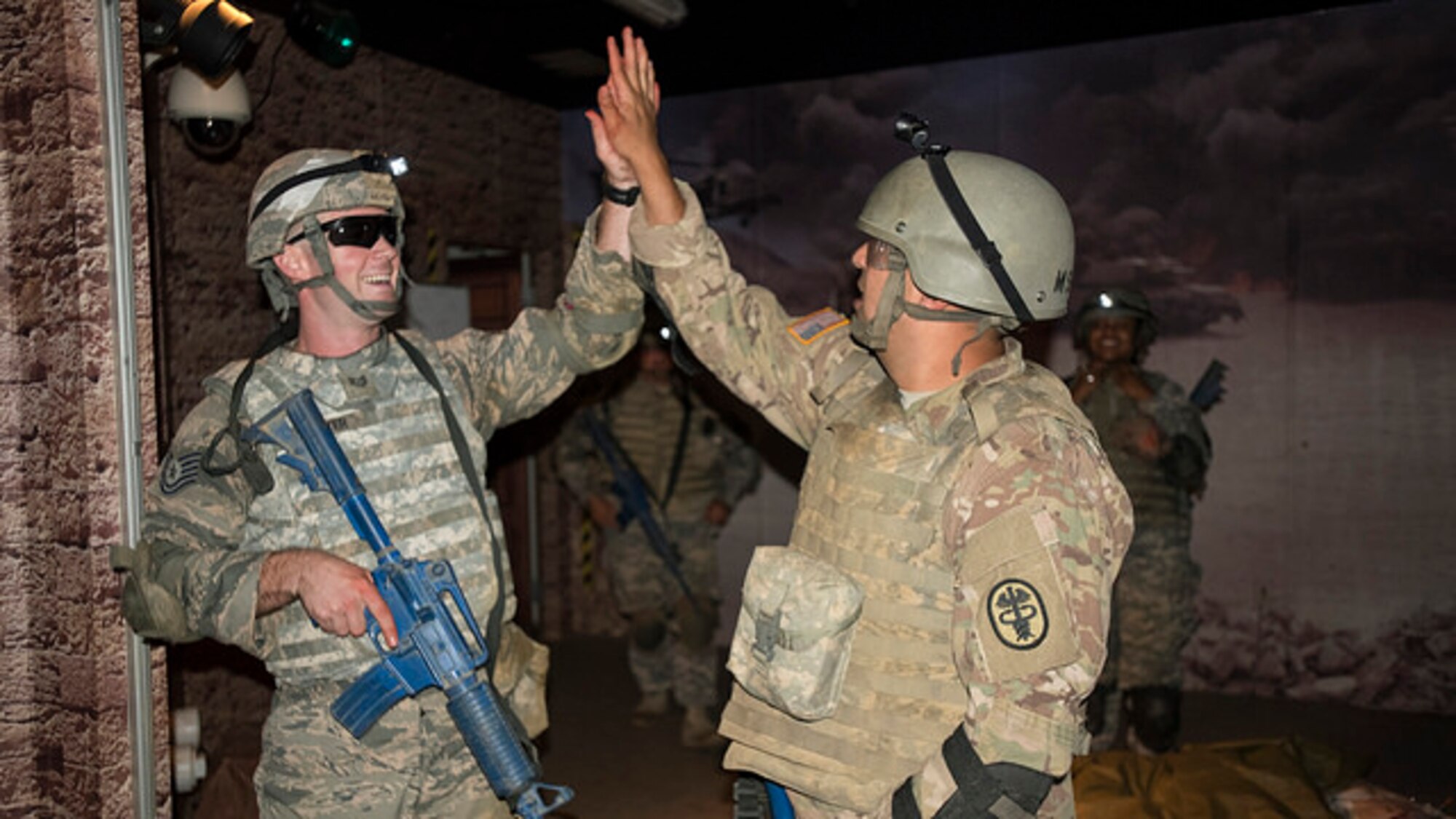 Tech. Sgt. Joshua B. Welter, 621st Contingency Response Squadron aircraft maintenance craftsman, and U.S. Army Sgt. Christopher A. Kilby, animal care specialist and NCO in charge of Joint Base McGuire-Dix-Lakehurst Veterinary Treatment Facility, high five each other after completing a portion of training at the Medical Simulations Training Center at Joint Base McGuire-Dix-Lakehurst, N.J. on Aug. 17, 2017. The MSTC provides training to all branches of the military, federal, and local law enforcement and fire agencies. (U.S. Air Force photo by Airman 1st Class Jessica Blair)