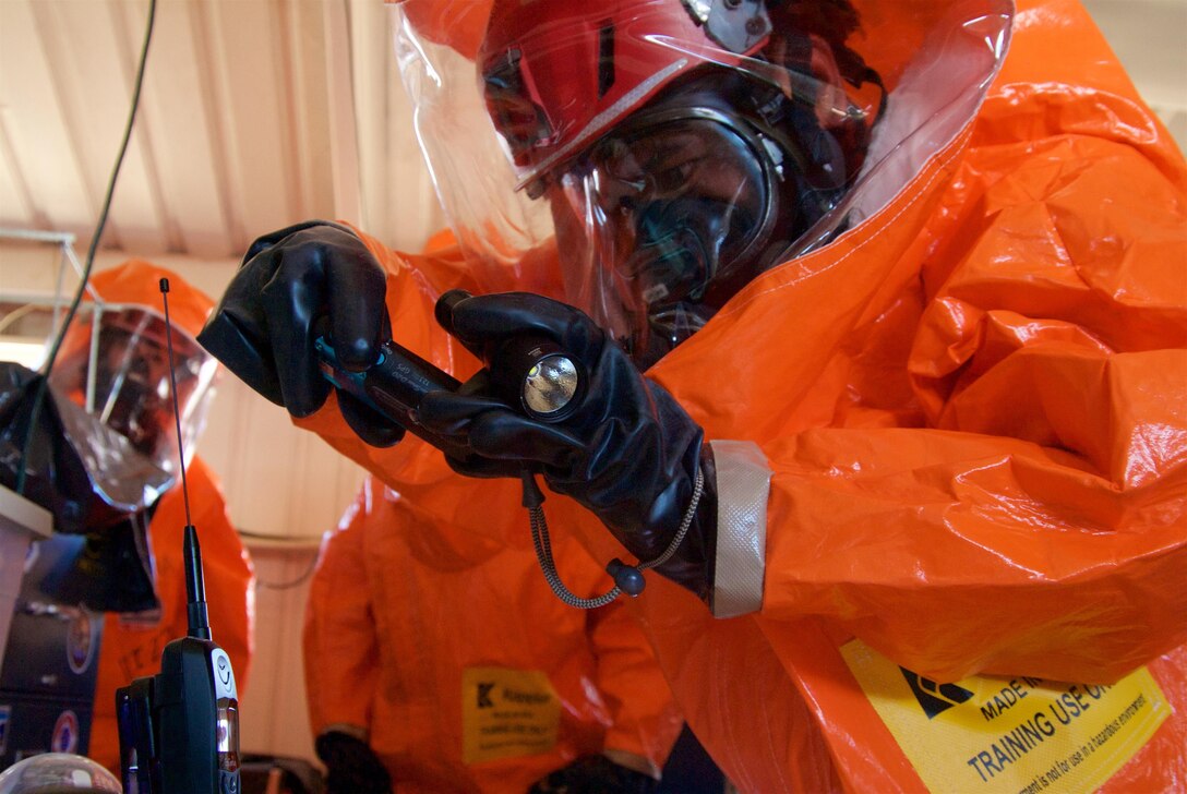A joint hazard assessment team member takes hazmat instrument readings in a simulated hot zone during Kauai County Exercise 2017 at the Pacific Missile Range Facility in Kauai, Hawaii, Aug. 29, 2017. JHAT teams are tasked with gathering intelligence and environmental conditions in hazmat hot zones. Hawaii Air National Guard photo by Senior Airman Orlando Corpuz