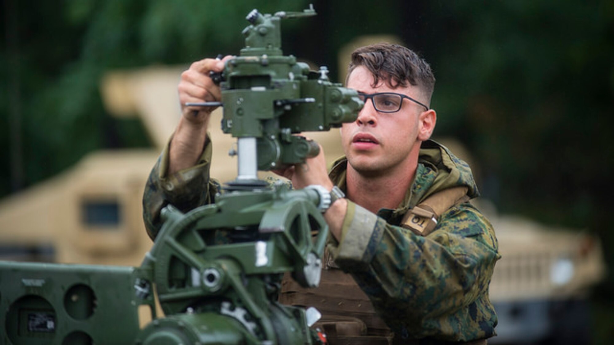 U.S. Marine Sgt. John C. Vassiliou, Battery G, 3rd Battalion 14th Marines field artillery cannoneer, ensures the M777A2 howitzer is leveled properly during artillery training at Joint Base McGuire-Dix-Lakehurst, N.J. on Aug. 18, 2017. The M777A2 is normally operated by a crew of eight but can be operated with a reduced detachment of five. (U.S. Air Force photo by Airman 1st Class Jessica Blair)