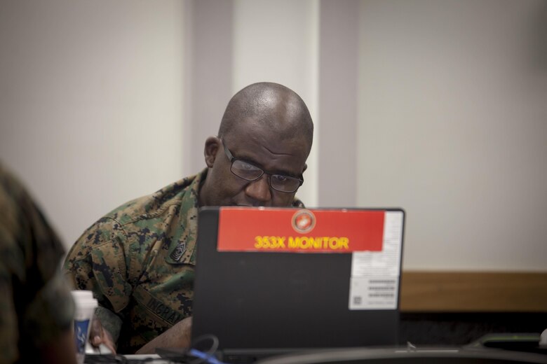 Master Gunnery Sgt. Eric Ingram, the motor transportation monitor with Headquarters Marine Corps Personnel Management Division, waits to speak to a U.S. Marine during the Manpower Management Enlisted Assignments Retention Roadshow aboard Marine Corps Base Hawaii on Aug. 21, 2017. Marines from various units aboard the base got a chance to meet face-to-face with their monitor and receive counseling, orders, and even get approved on the spot for reenlistment. (U.S. Marine Corps photo by Lance Cpl. Matthew Kirk)