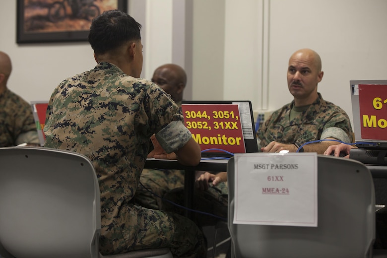 Sgt. James Takagi, the base inspector noncommissioned officer-in-charge with Headquarters Battalion,Marine Corps Base Hawaii (MCBH) speaks to Master Gunnery Sgt. James Drain, the supply administration and operations and the distribution management specialist monitor with Headquarters Marine Corps Personnel Management Division, during the Manpower Management Enlisted Assignments Retention Roadshow aboard MCBH on Aug. 21, 2017. U.S. Marines from various units aboard the base got a chance to meet face-to-face with their monitor and receive counseling, orders, and even get approved on the spot for reenlistment. (U.S. Marine Corps photo by Lance Cpl. Matthew Kirk)