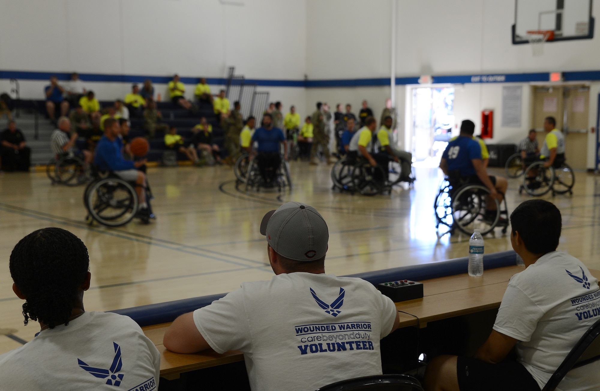 Volunteers for the Air Force Wounded Warrior Program keeps score during the 2017 Joint Adaptive Sports Camp wheelchair basketball games Aug. 29, 2017, at Joint Base Lewis-McChord, Wash.
