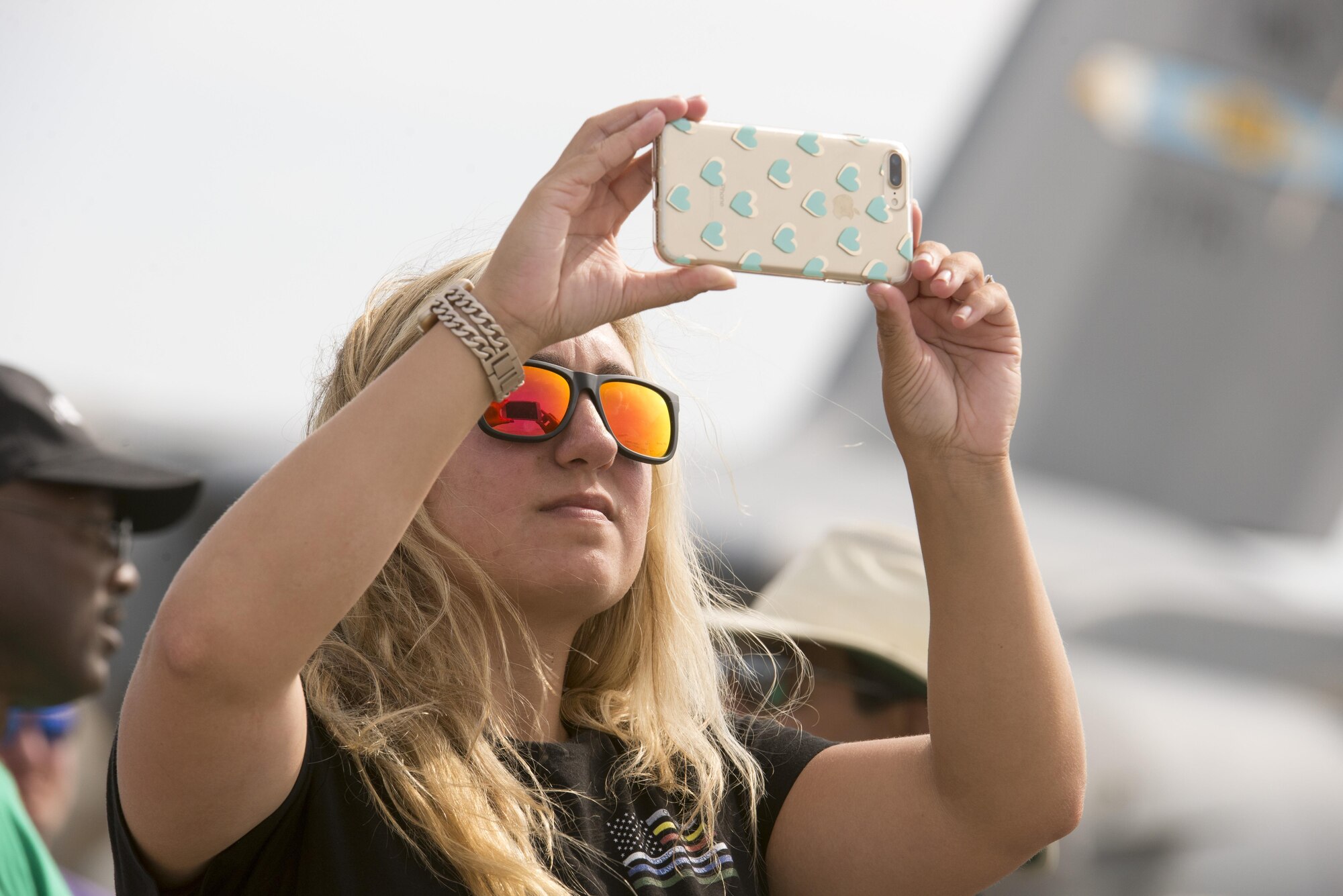 A Team Dover guest records aerial performances during the 2017 Thunder Over Dover Open House Aug. 27, 2017, on Dover Air Force Base, Del. The open house was a free, two-day event that featured more than 20 aerial demonstrations, static aircraft displays and other events. (U.S. Air Force photo by Staff Sgt. Jared Duhon)