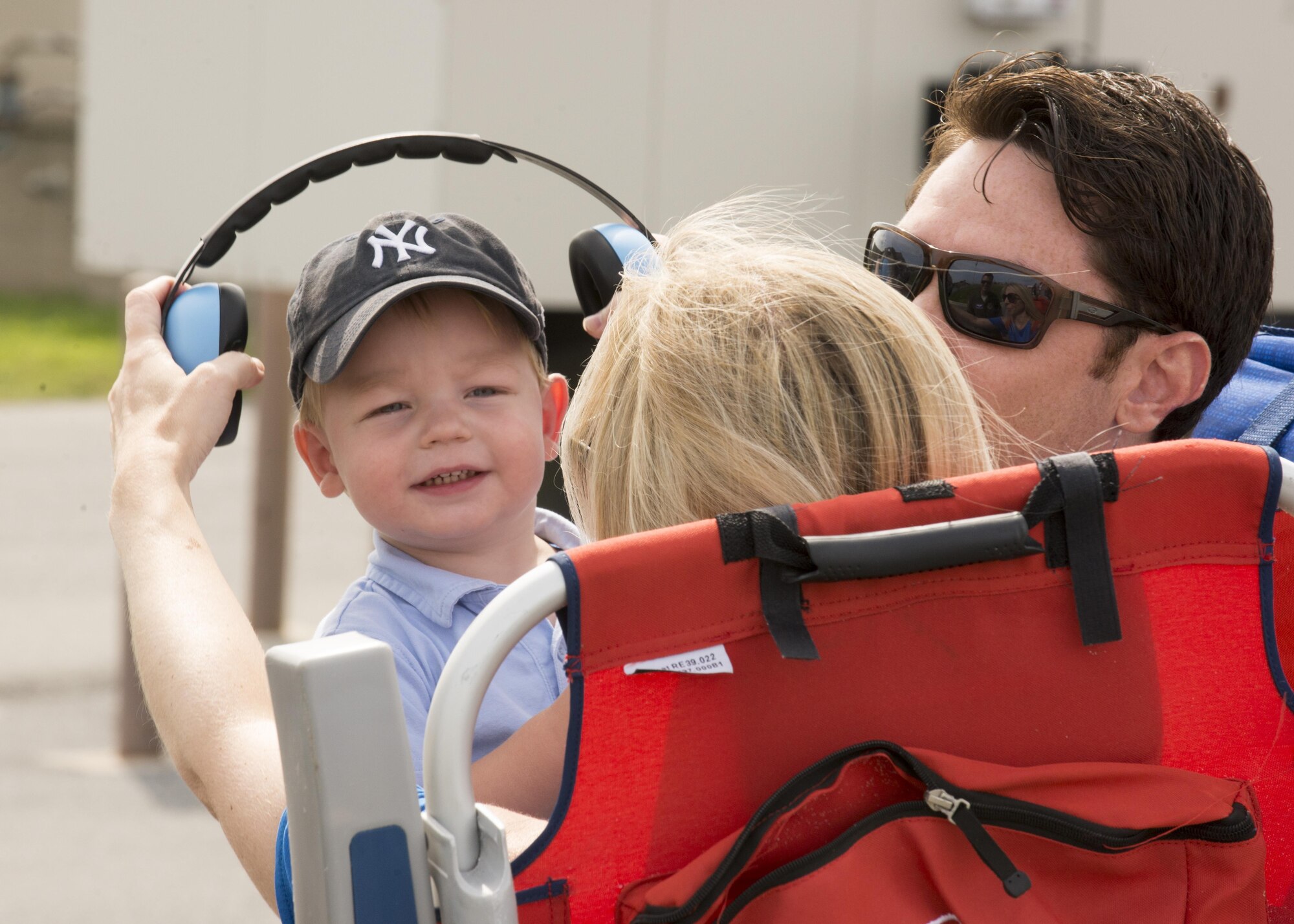 A mother puts hearing protection on her son during the 2017 Thunder Over Dover Open House Aug. 27, 2017, on Dover Air Force Base, Del. Dover AFB opened its gates to the public for a free, two-day event as a way to thank the local community for their ongoing support of the base’s mission. (U.S. Air Force photo by Staff Sgt. Jared Duhon)