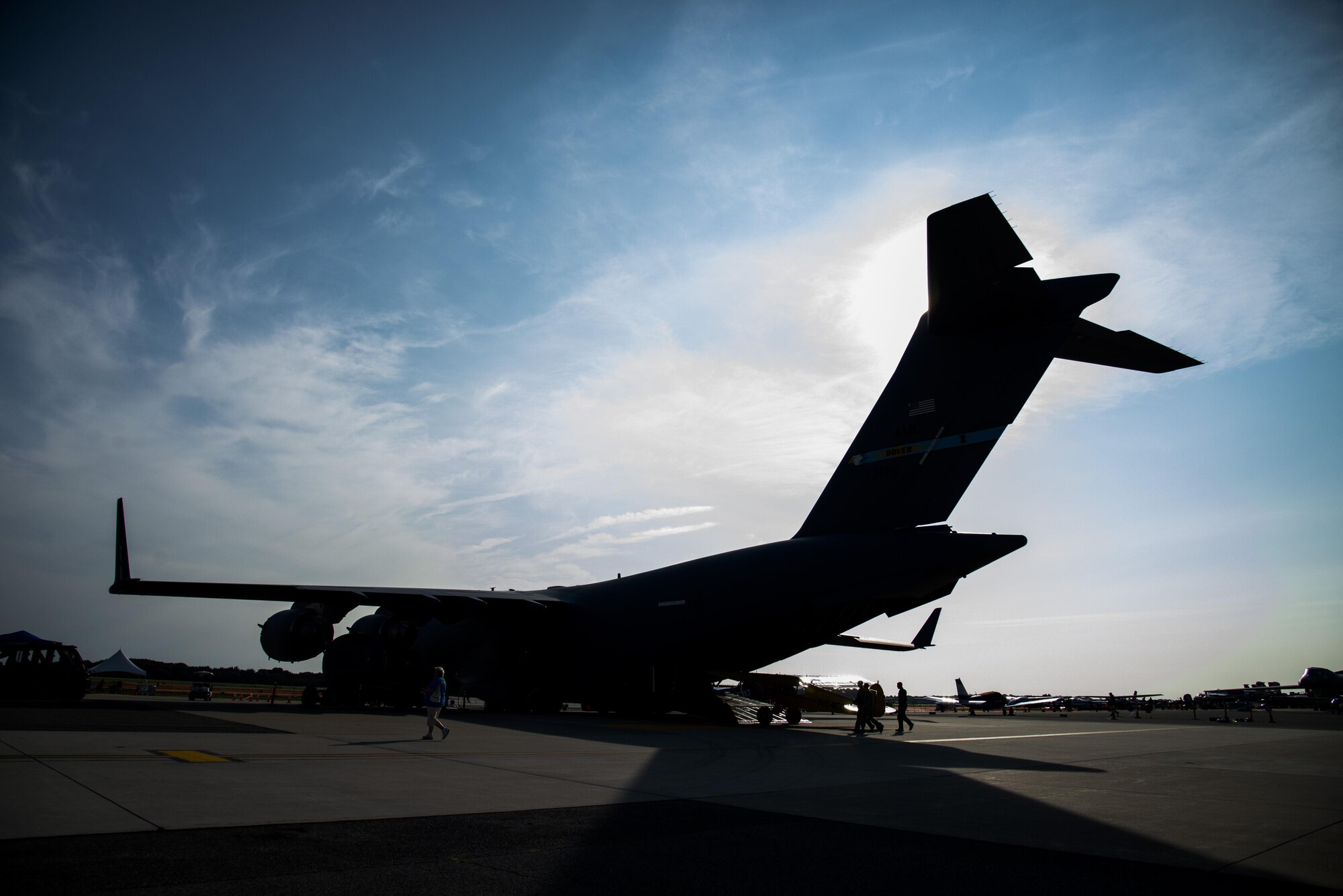 A silhouette of a C-17 Globemaster III before the start of the day during the 2017 Thunder Over Dover Open House Aug. 27, 2017, on Dover Air Force Base, Del. The C-17 was pulled by an Australian strong man on both days of the open house. (U.S. Air Force illustration by Staff Sgt. Jared Duhon)