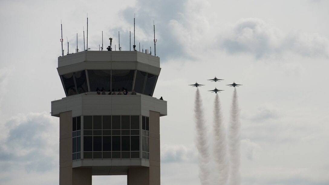 The U.S. Air Force Air Demonstration Squadron Thunderbirds move into the diamond formation fly pass Dover Air Force Base’s air traffic control tower during the Thunder Over Dover Open House Aug. 27, 2017. The Thunderbirds performed precision flying maneuvers during the 2017 Thunder Over Dover Open House and Airshow Aug. 26 – 27. (U.S. Air Force photo by Senior Airman Zachary Cacicia)