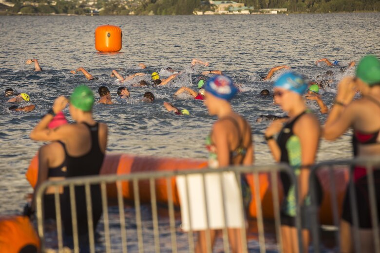 Male race participants start the swim portion of the Tradewind Triathlon aboard Marine Corps Air Station (MCAS) Kaneohe Bay, Aug. 27, 2017. The Tradewind Triathlon involves a 500 meter swim in Kaneohe Bay, a 13 mile bike ride on the MCAS Kaneohe Bay flight line, and a 3 mile run around the base. The event is part of the Commanding Officer Race Series and is open for the public to participate in. (U.S. Marine Corps photo by Lance Cpl. Isabelo Tabanguil)