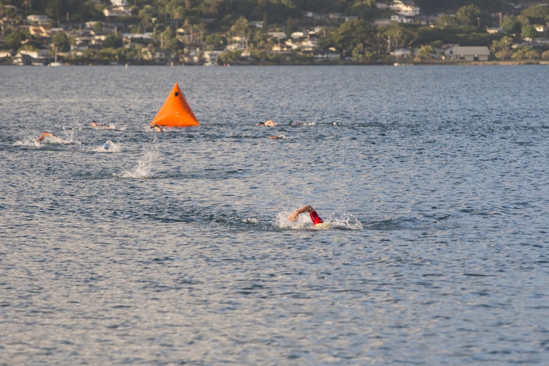 Race participants reach the end of the swim portion of the Tradewind Triathlon at Marine Corps Air Station (MCAS) Kaneohe Bay, Aug. 27, 2017. The Tradewind Triathlon involves a 500 meter swim in Kaneohe Bay, a 13 mile bike ride on the MCAS Kaneohe Bay flight line, and a 3 mile run around the base. The event is part of the Commanding Officer Race Series and is open for the public to participate in. (U.S. Marine Corps photo by Lance Cpl. Isabelo Tabanguil)