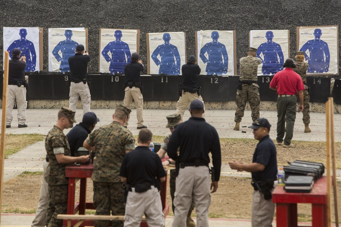 Military police officers with the Provost Marshal’s Office conduct an annual pistol and shotgun qualification at Range 6 aboard Marine Corps Base Hawaii, Aug. 29, 2017. The qualification involves engaging targets with a Beretta M9 service pistol at close range, moving from cover to cover, and firing a shotgun while closing distance with the targets. (U.S. Marine Corps photo by Lance Cpl. Isabelo Tabanguil)