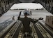 A loadmaster with the 6th Airlift Squadron directs 375th Logistics Readiness Squadron personnel toward a C-17 Globemaster III, which will transport cargo and 375th Aeromedical Evacuation Squadron personnel to Little Rock Air Force Base, Ark. to provide medical relief after Hurricane Harvey caused catastrophic floods in the states of Texas and Louisiana, Scott Air Force Base, Ill., Aug. 30, 2017.  The 375th LRS loaded 6.5 tons of medical supplies onto a C-17 Globemaster III for the nine-person medical team. The 375th AES crew, prepared to provide relief for 30 days, will be staged at Little Rock Air Force Base, where they will pick up high-priority patients from George Bush Intercontinental Airport and transport them to one of seven hospital locations across the states of Texas, Oklahoma, Louisiana, Tennessee, Mississippi, and Alabama.   (U.S. Air Force photo by Tech. Sgt. Jodi Martinez)