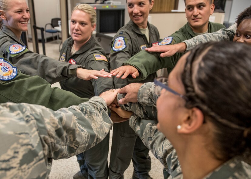 Members of the 375th Aeromedical Evacuation Squadron come together before the team mobilizes in support Hurricane Harvey relief and response efforts, Scott Air Force Base, Ill., Aug. 30, 2017. The 375th Logistics Readiness Squadron loaded 6.5 tons of medical supplies onto a C-17 Globemaster III for the nine-person medical team. The 375th AES crew, prepared to provide relief for 30 days, will be staged at Little Rock AFB, Ark., where they will pick up high-priority patients from George Bush Intercontinental Airport in Houston, and transport them to one of seven hospital locations across the states of Texas, Oklahoma, Louisiana, Tennessee, Mississippi, and Alabama. (U.S. Air Force photo/Tech. Sgt. Jodi Martinez)