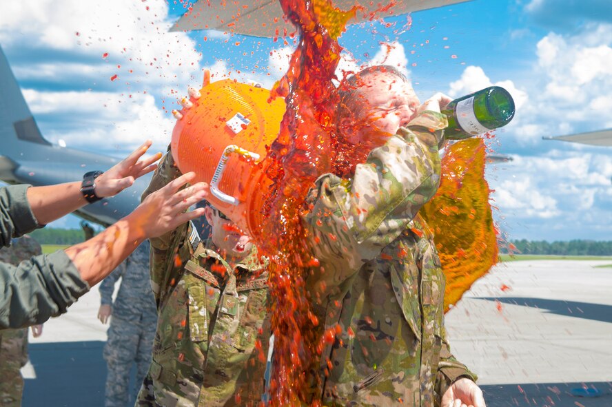 Members of the 347th Rescue Group, celebrate as they pour sea dye on Chief Master Sgt. Brandon Broughman, 347th RQG superintendent, after his final flight, Aug. 17, 2017, at Moody Air Force Base, Ga. Broughman concluded his 30-year career as a loadmaster on Sept. 1. During his tenure, he dedicated service to more than 5 variants of C-130’s in air mobility and tactical airlift support. (U.S. Air Force photo by Senior Airman Greg Nash)