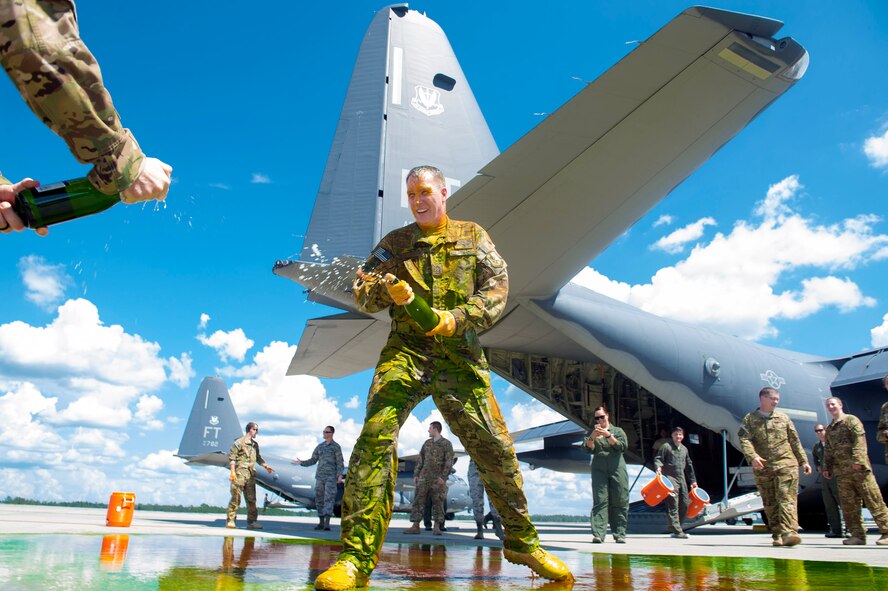 Chief Master Sgt. Brandon Broughman, 347th Rescue Group superintendent, celebrates with his comrades after his final flight, Aug. 17, 2017, at Moody Air Force Base, Ga. Broughman concluded his 30-year career as a loadmaster on Sept. 1. During his tenure, he dedicated service to more than 5 variants of C-130’s in air mobility and tactical airlift support. (U.S. Air Force photo by Senior Airman Greg Nash)