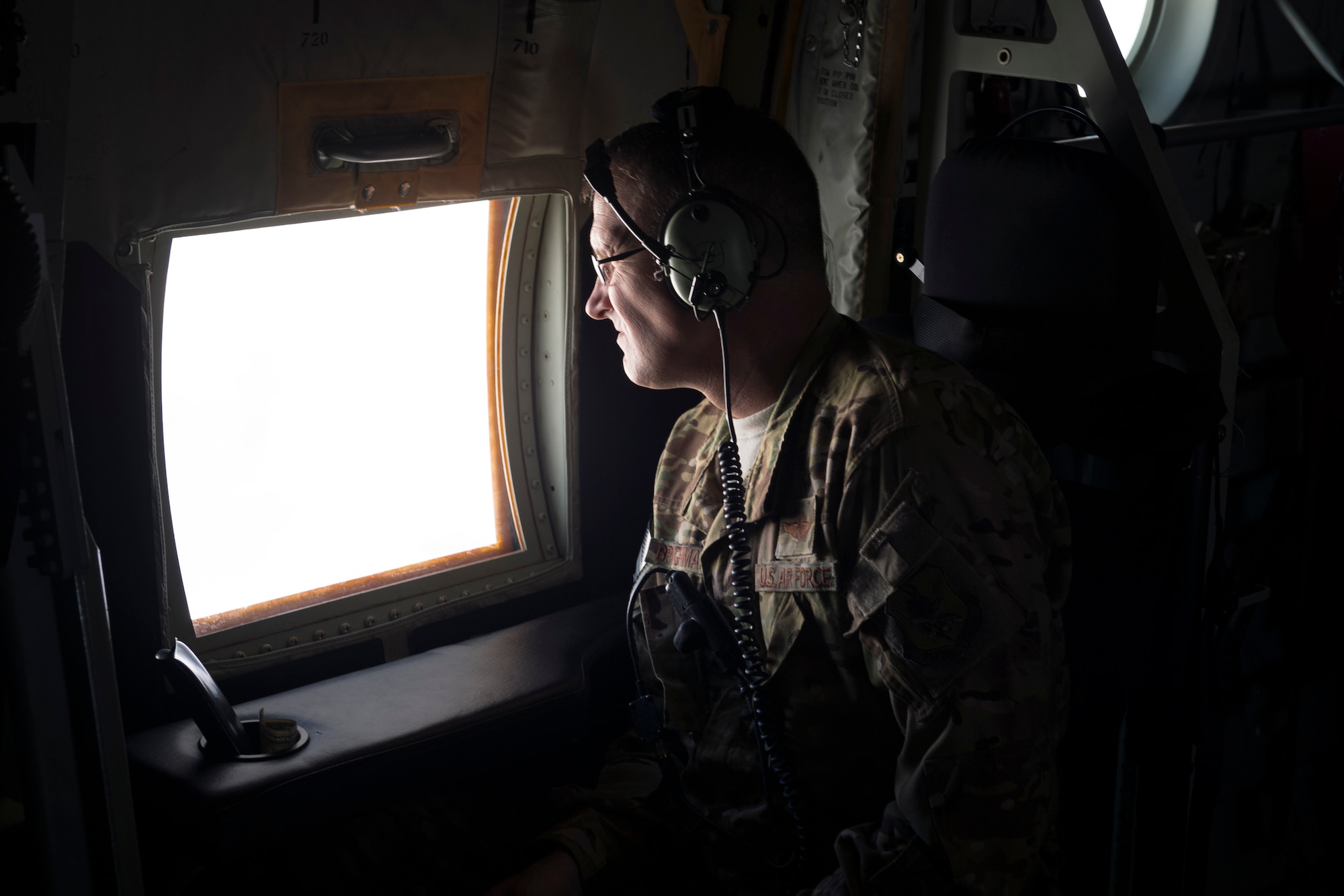 Chief Master Sgt. Brandon Broughman, 347th Rescue Group superintendent, looks out of an HC-130J Combat King II for the last time as a loadmaster during his final flight, Aug. 17, 2017, in coastal Florida. Broughman concluded his 30-year career as a loadmaster on Sept. 1. During his tenure, he dedicated service to more than 5 variants of C-130’s in air mobility and tactical airlift support. (U.S. Air Force photo by Tech. Sgt. Timothy Gallagher)