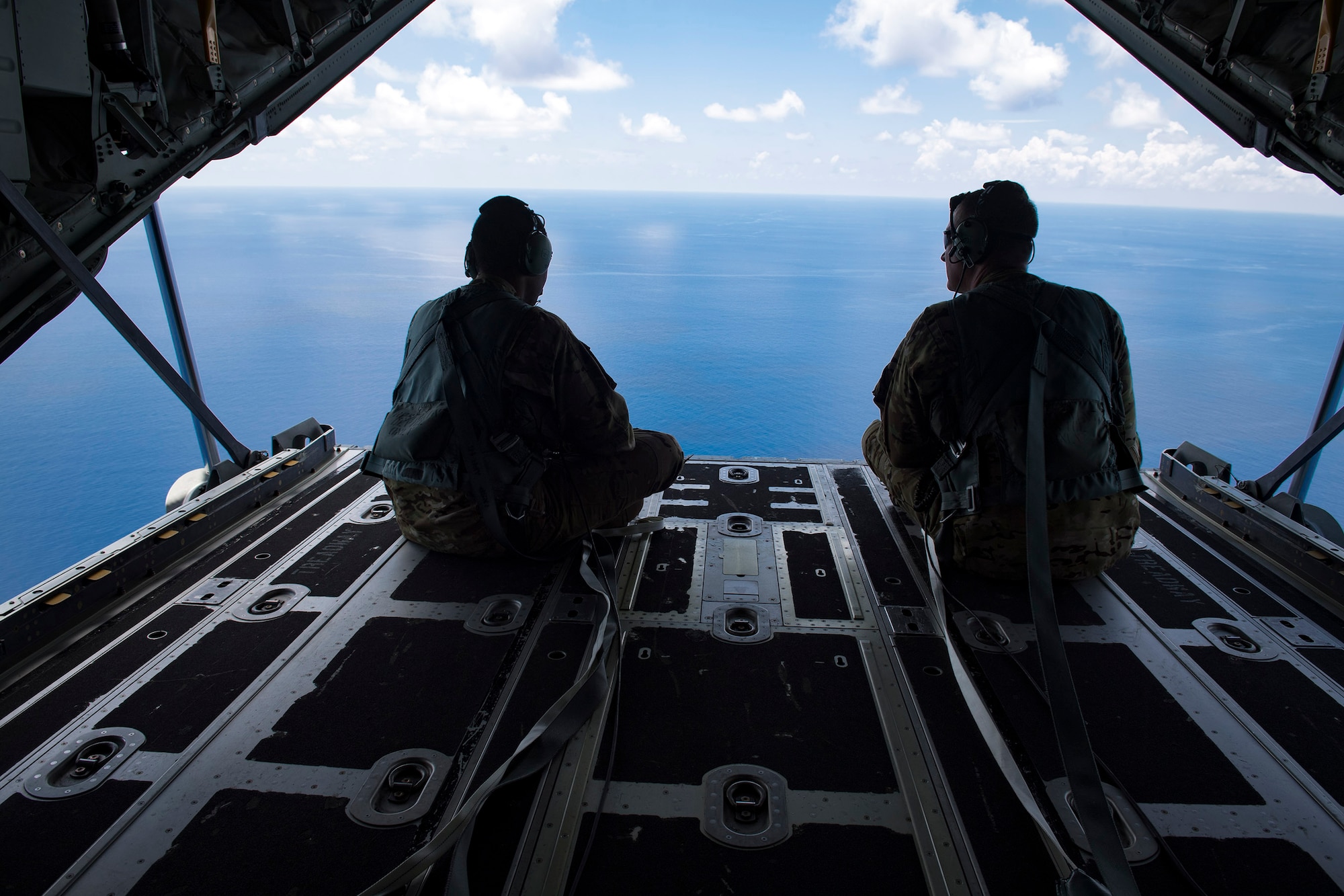 Chief Master Sgt. Brandon Broughman, 347th Rescue Group superintendent, sits alongside Tech. Sgt. Curtis Copeland, 71st Rescue Squadron loadmaster, during Broughman’s final flight on a HC-130J Combat King II, Aug. 17, 2017, in coastal Florida. Broughman concluded his 30-year career as a loadmaster. During his tenure, he dedicated service to more than 5 variants of C-130’s in air mobility and tactical airlift support. (U.S. Air Force photo by Tech. Sgt. Timothy Gallagher)